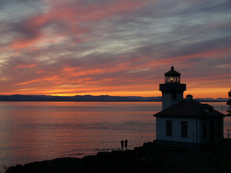 Lighthouse at Sunset — Orange, Serene, Photograph, Sea, Mountains, People