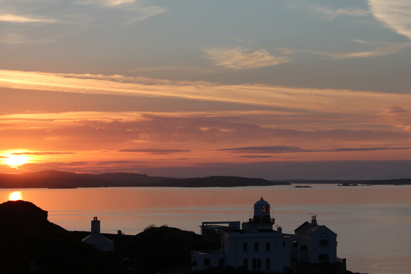 Lighthouse at Sunset — Orange, Serene, Photograph, Sea