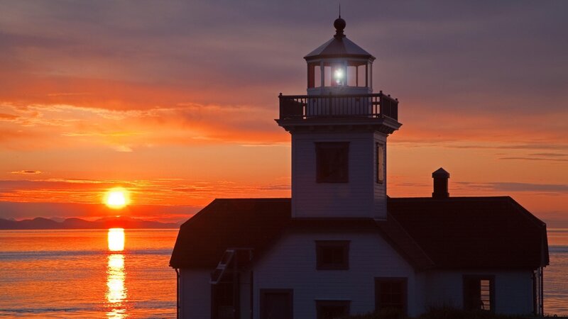 Lighthouse at Sunset — Orange, Serene, Photograph, Sun, Ocean, Mountains
