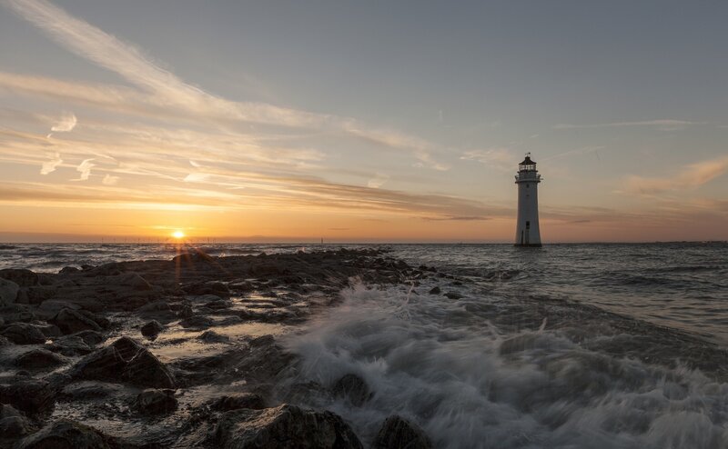 Lighthouse at Sunset — Orange, Serene, Photograph, Sun, Ocean, Rocks