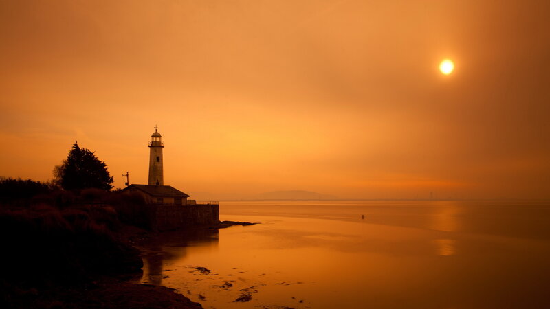 Lighthouse at Sunset — Orange, Serene, Photograph, Sun, Sea, Tree
