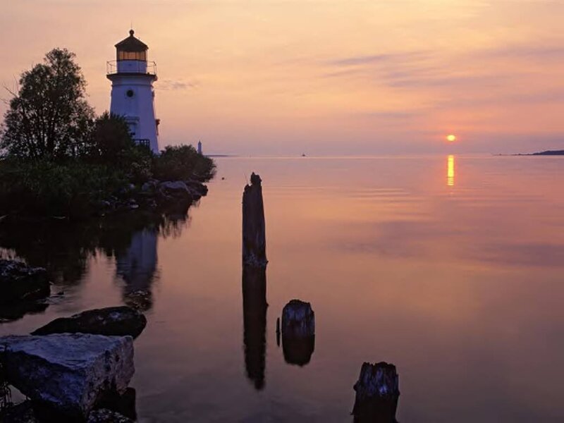Lighthouse at Sunset — Orange, Serene, Photograph, Sun, Water, Trees