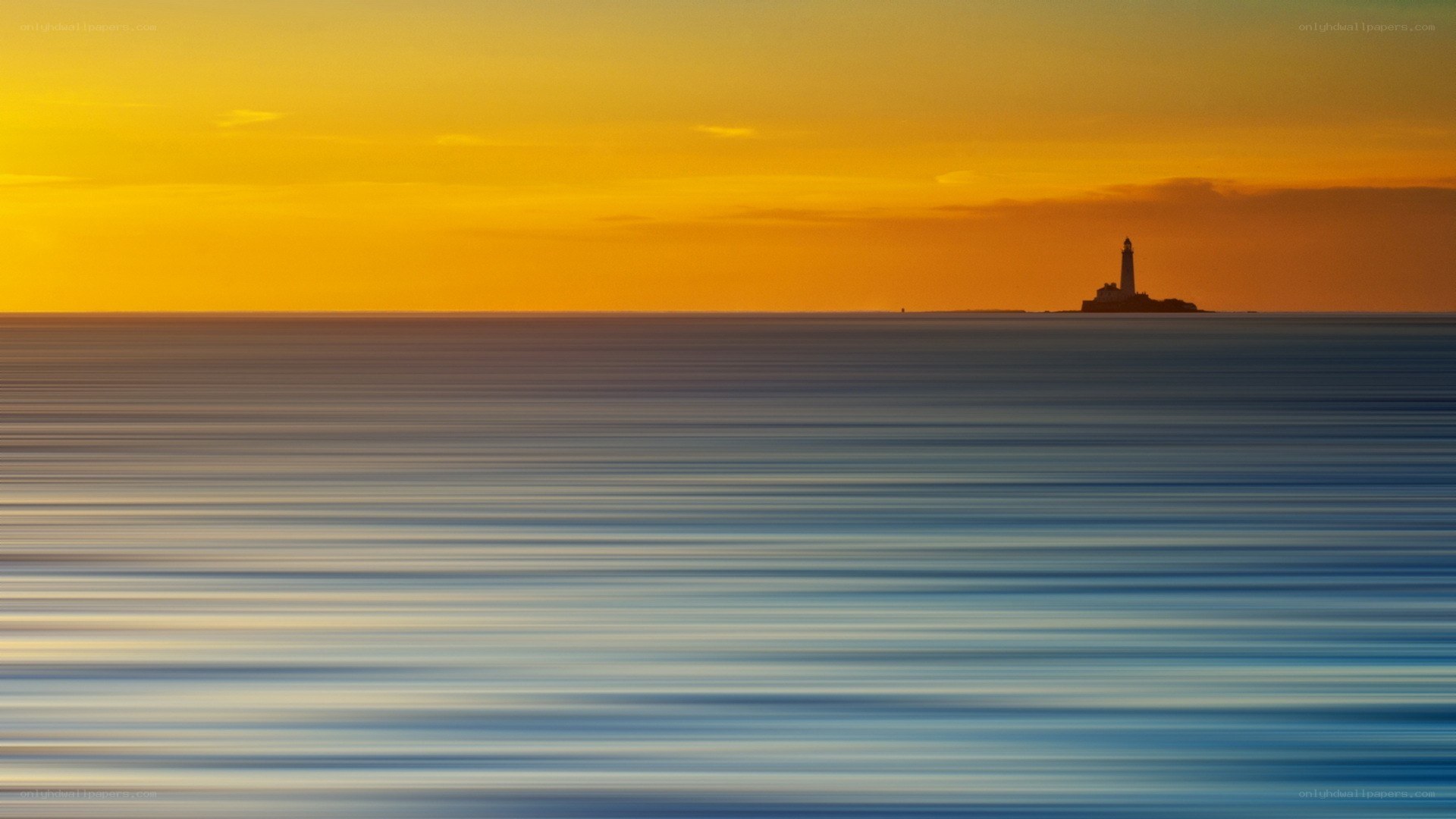 lighthouse at sunset over calm sea