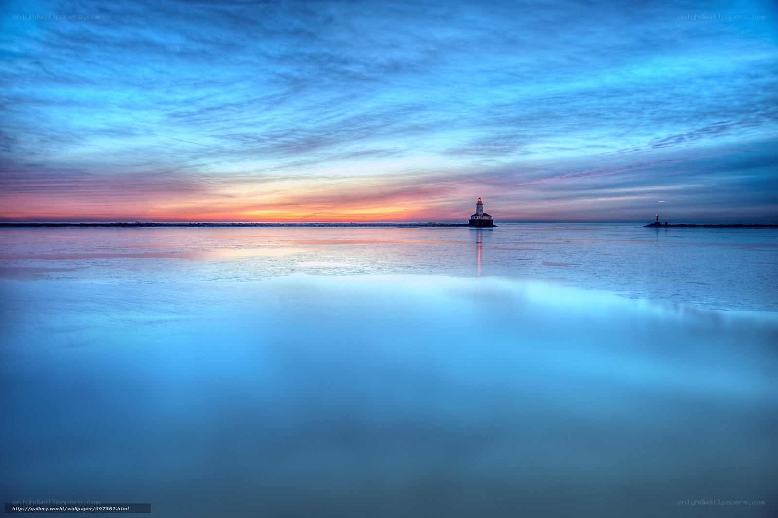 Lighthouse at sunset over calm water