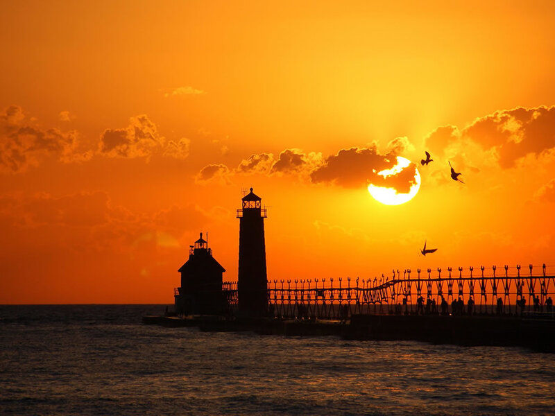 Lighthouse at sunset with birds