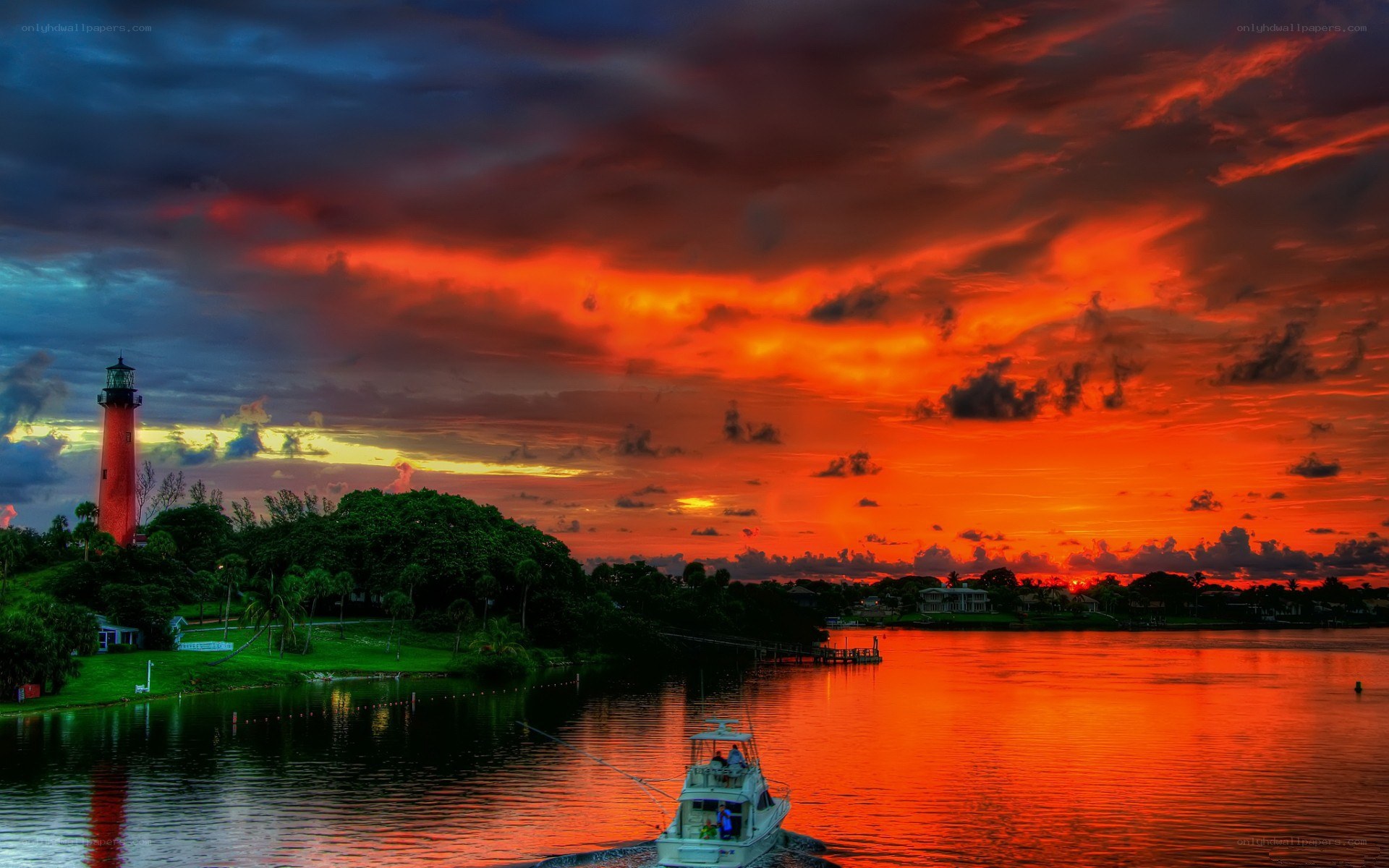 Lighthouse at sunset with boat