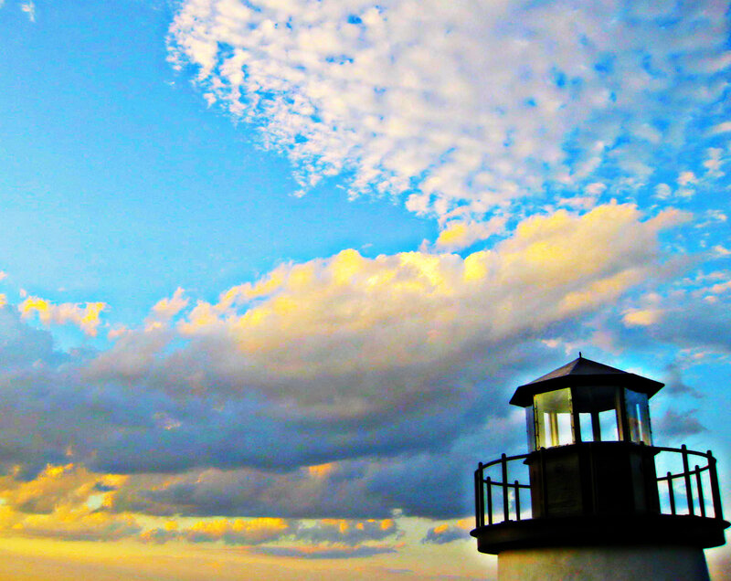 Lighthouse at sunset with clouds