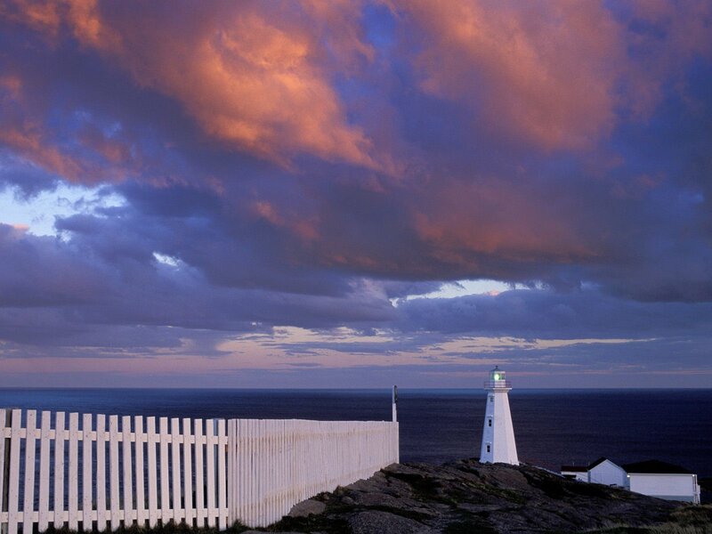 Lighthouse at sunset with cloudy sky