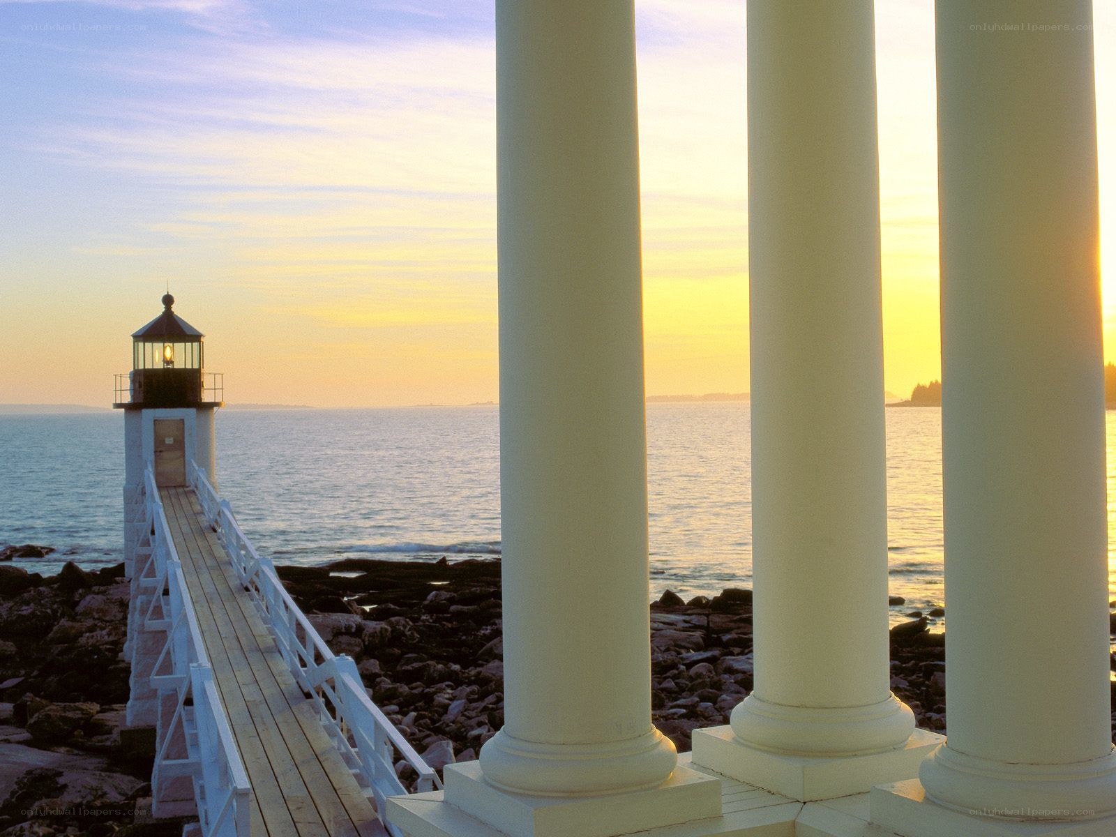 Lighthouse at sunset with columns