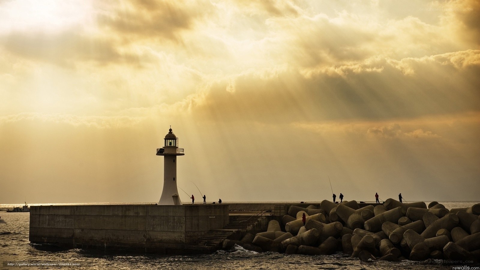 Lighthouse at sunset with fishermen