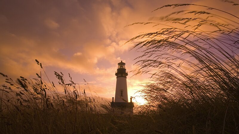 Lighthouse at sunset with grass