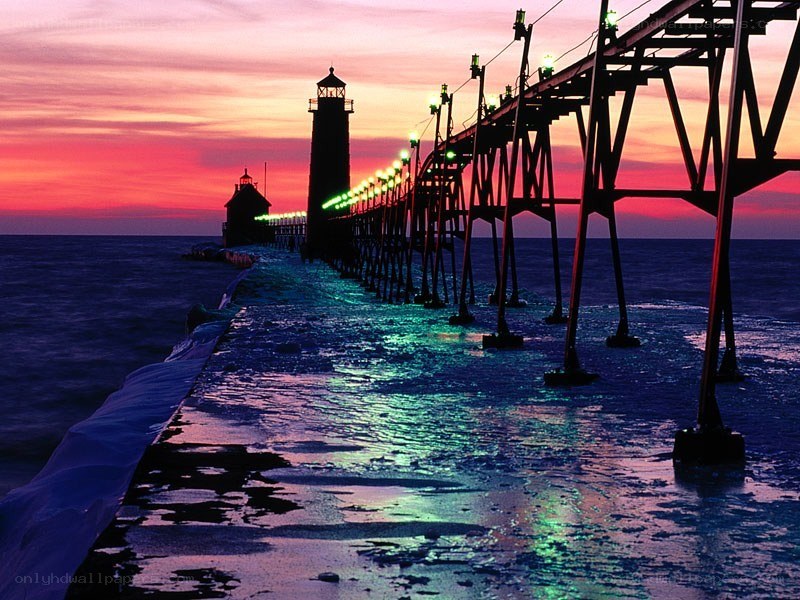 Lighthouse at sunset with ice