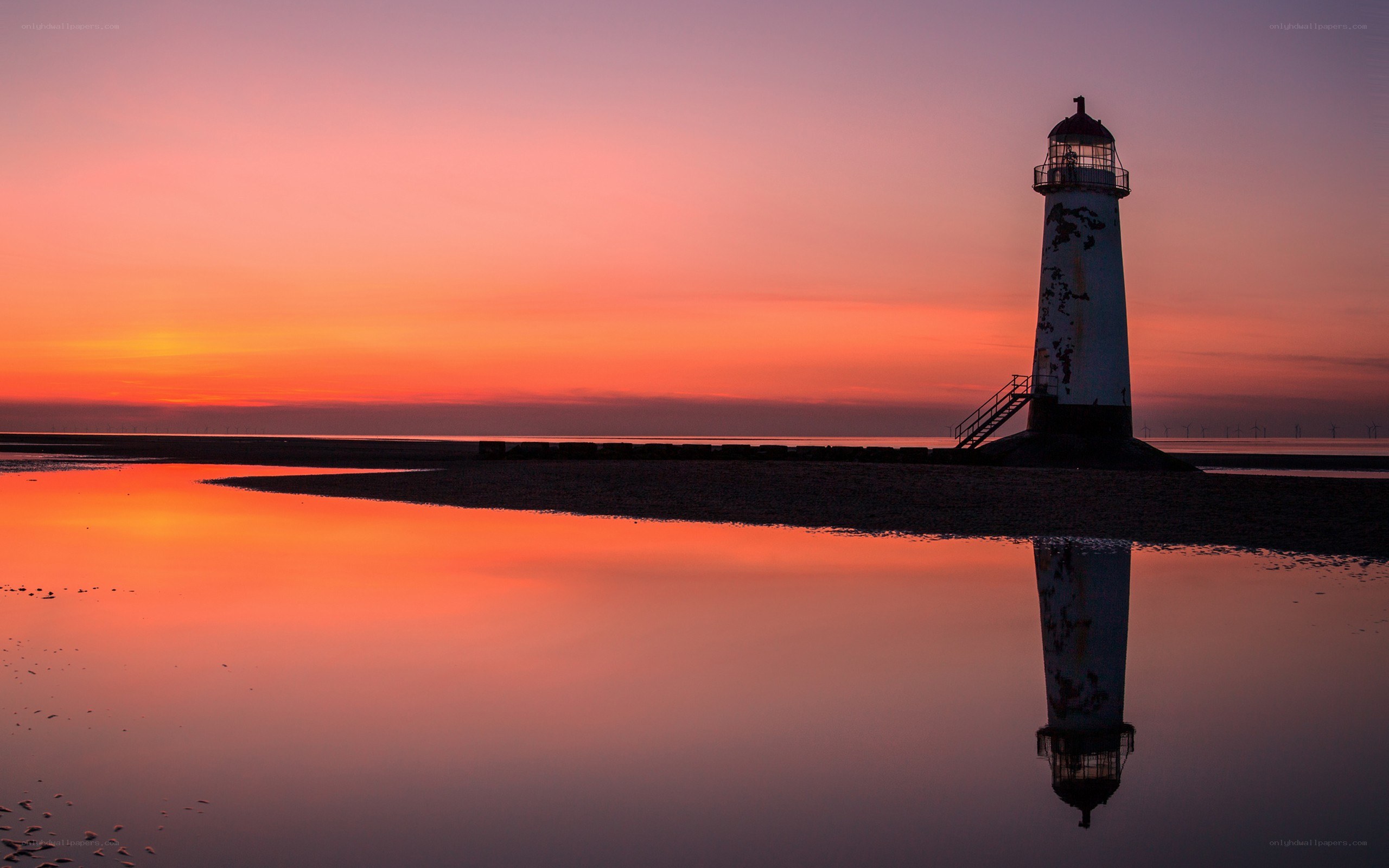 Lighthouse at sunset with reflection