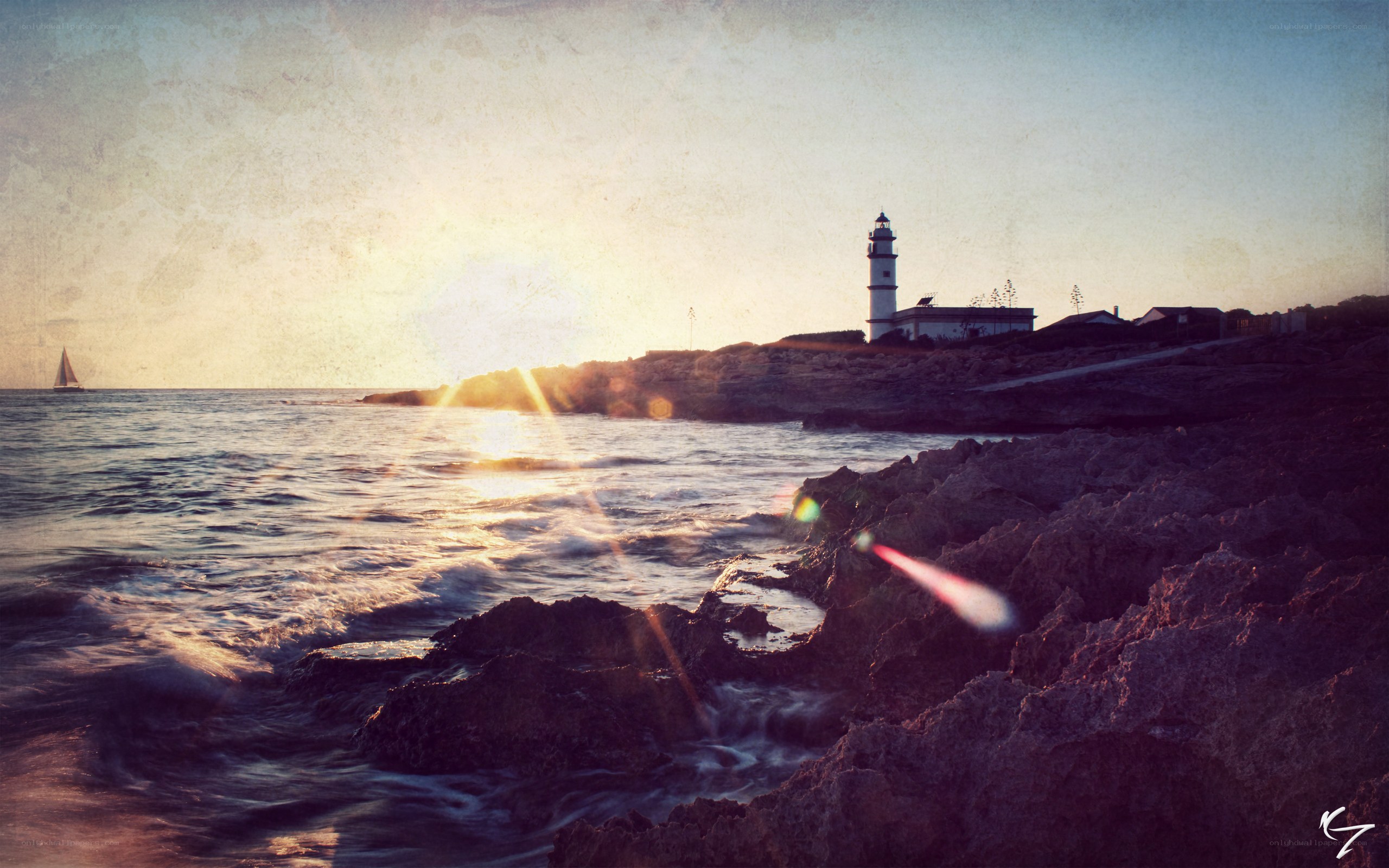 Lighthouse at sunset with sailboat