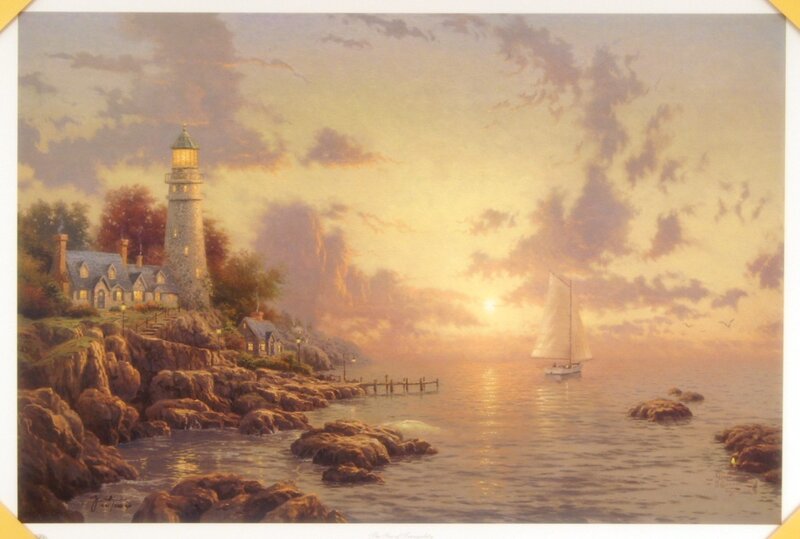 Lighthouse at sunset with sailboat