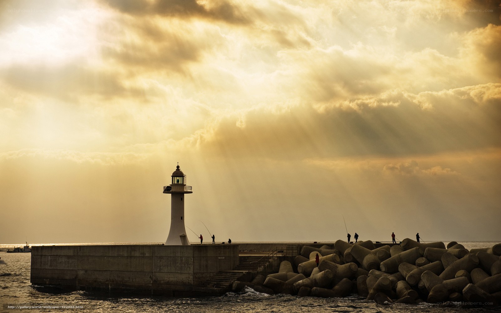 Lighthouse at sunset with sunbeams