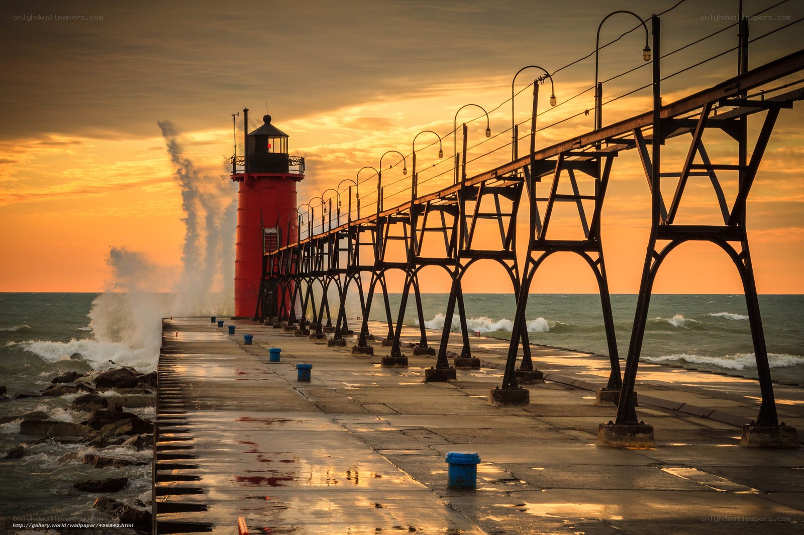 Lighthouse at sunset with waves