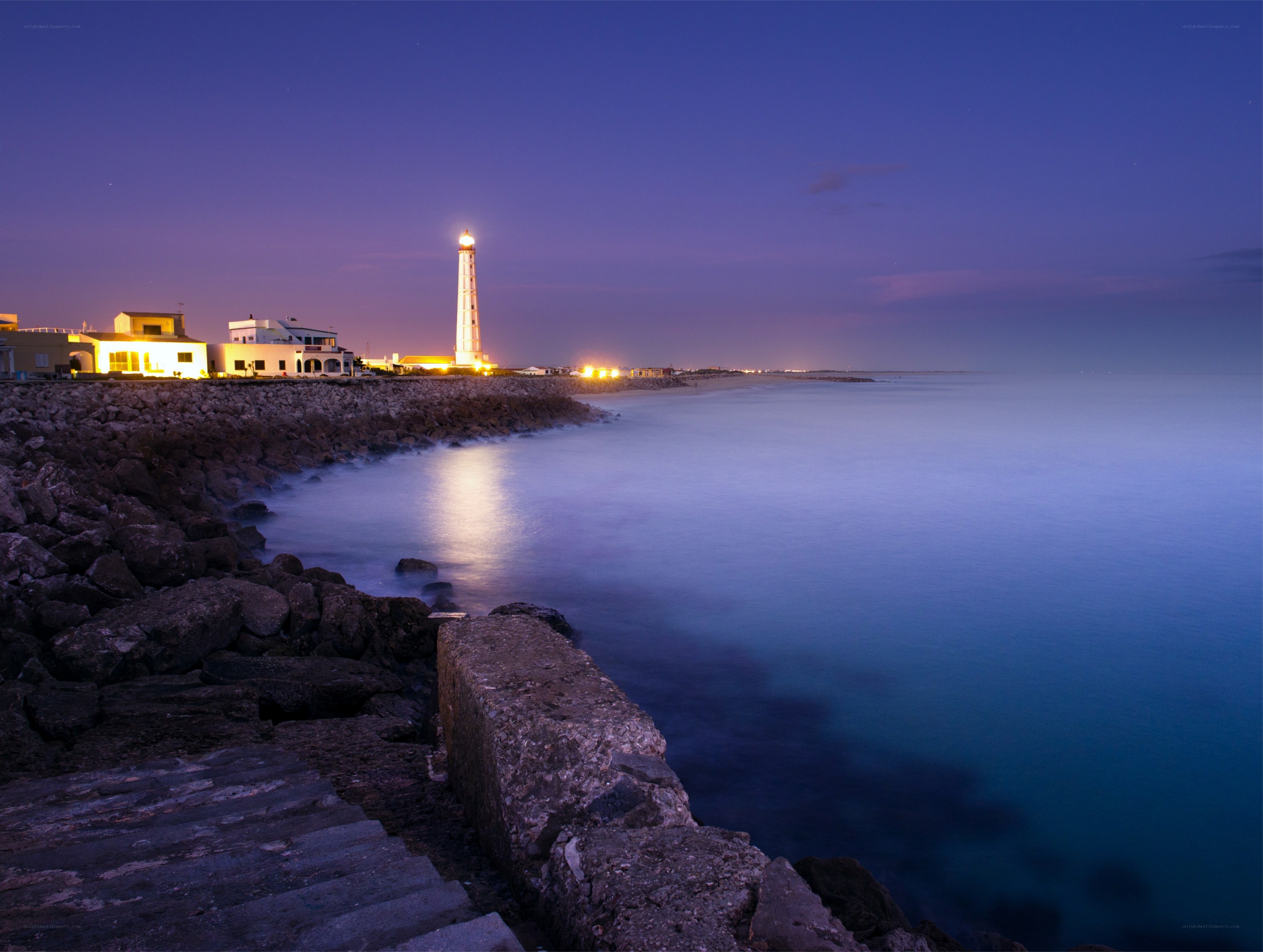 lighthouse at twilight by the sea