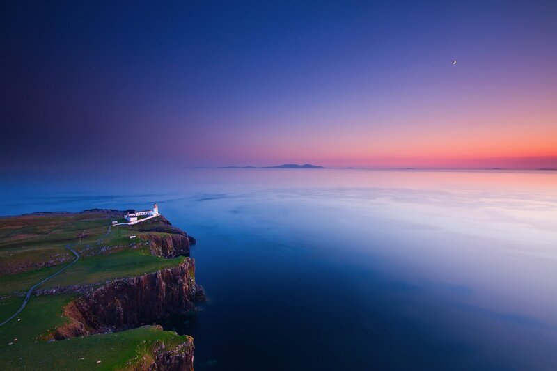 Lighthouse at twilight on a cliff