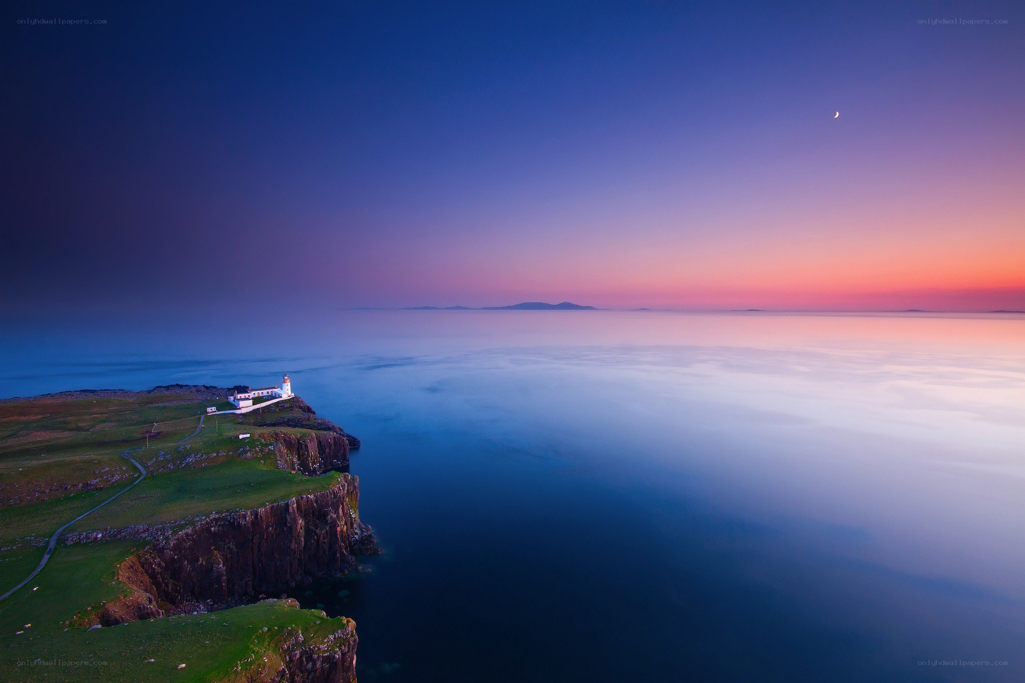 Lighthouse at twilight on a cliff