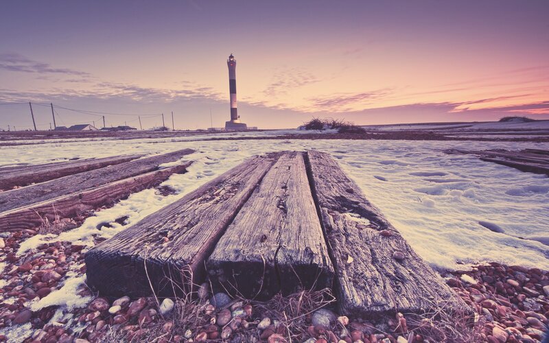 Lighthouse at winter sunset