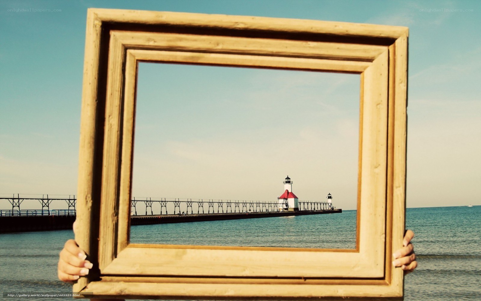 Lighthouse framed by hands