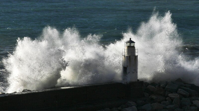 Lighthouse hit by crashing waves