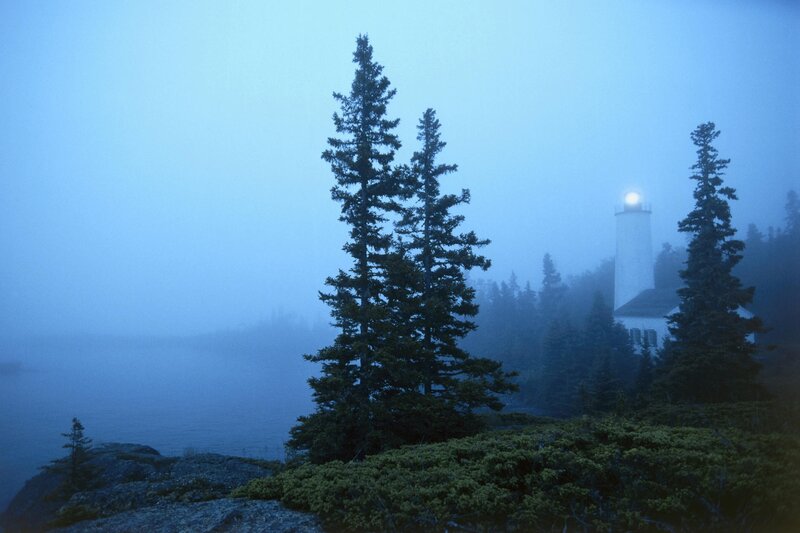 lighthouse in foggy coastal scene