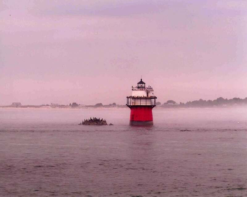 Lighthouse in foggy water