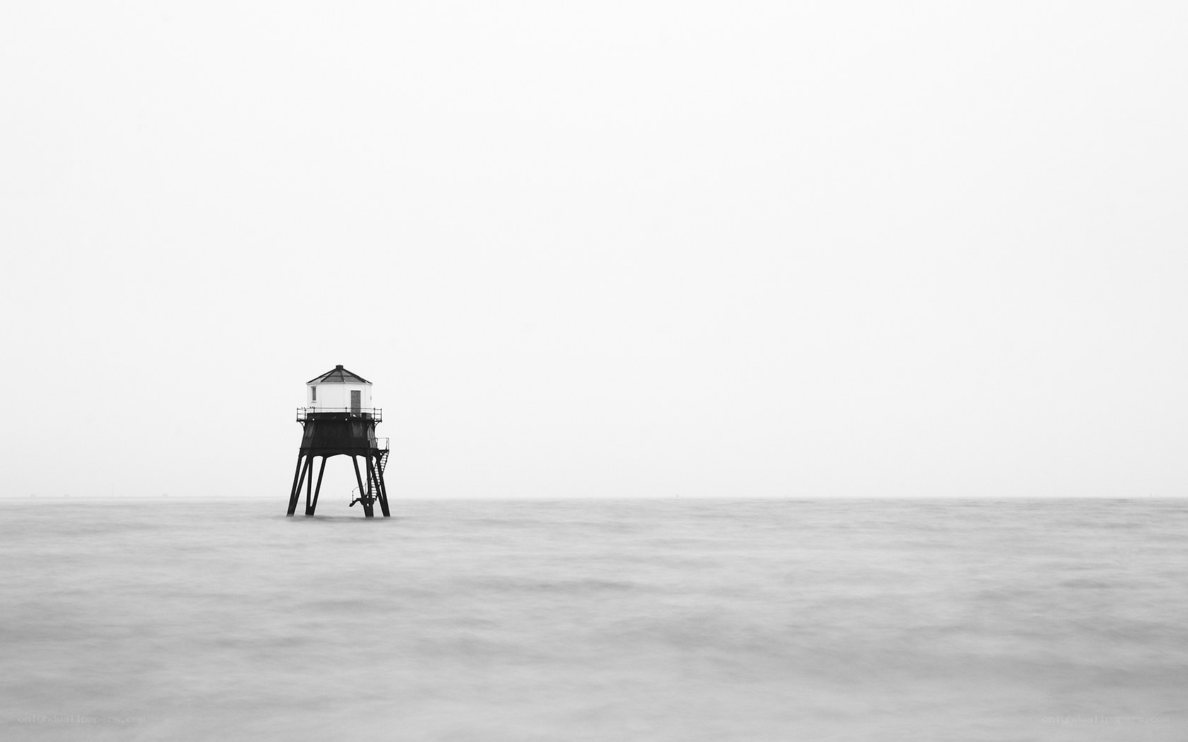 lighthouse in misty sea