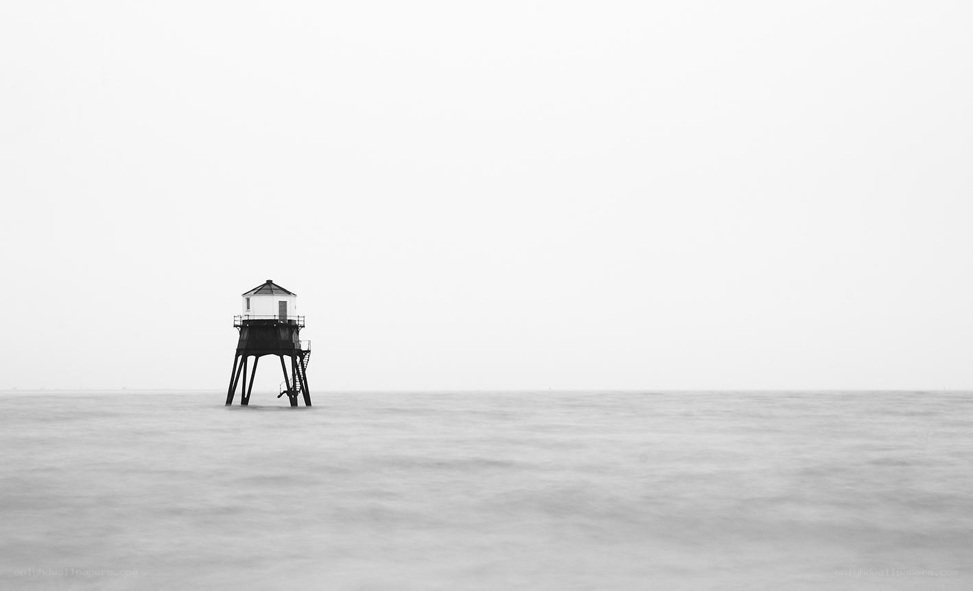 lighthouse in misty sea