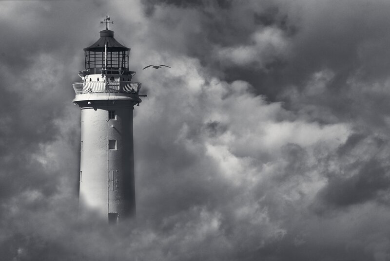 Lighthouse in Stormy Sky
