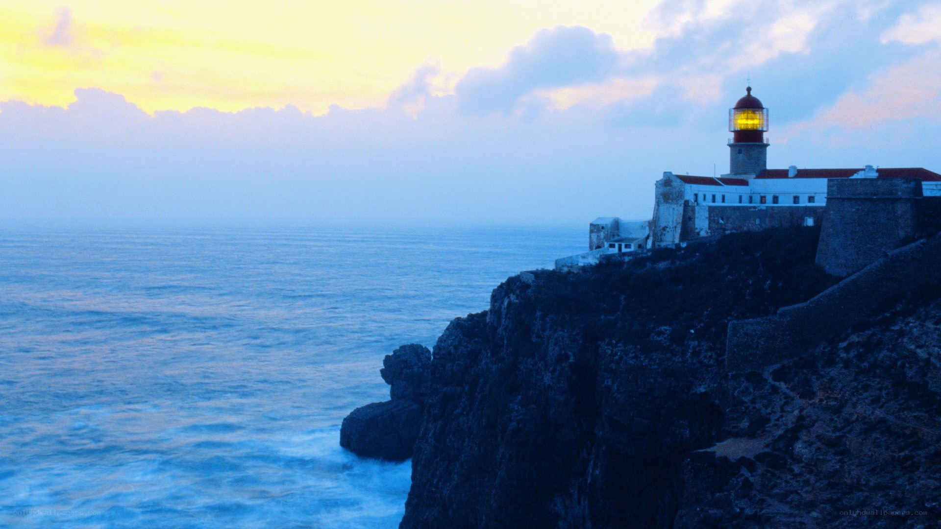 Lighthouse on a cliff at dusk