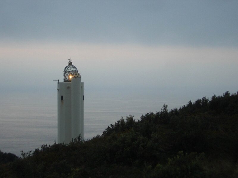lighthouse on a cliff at dusk
