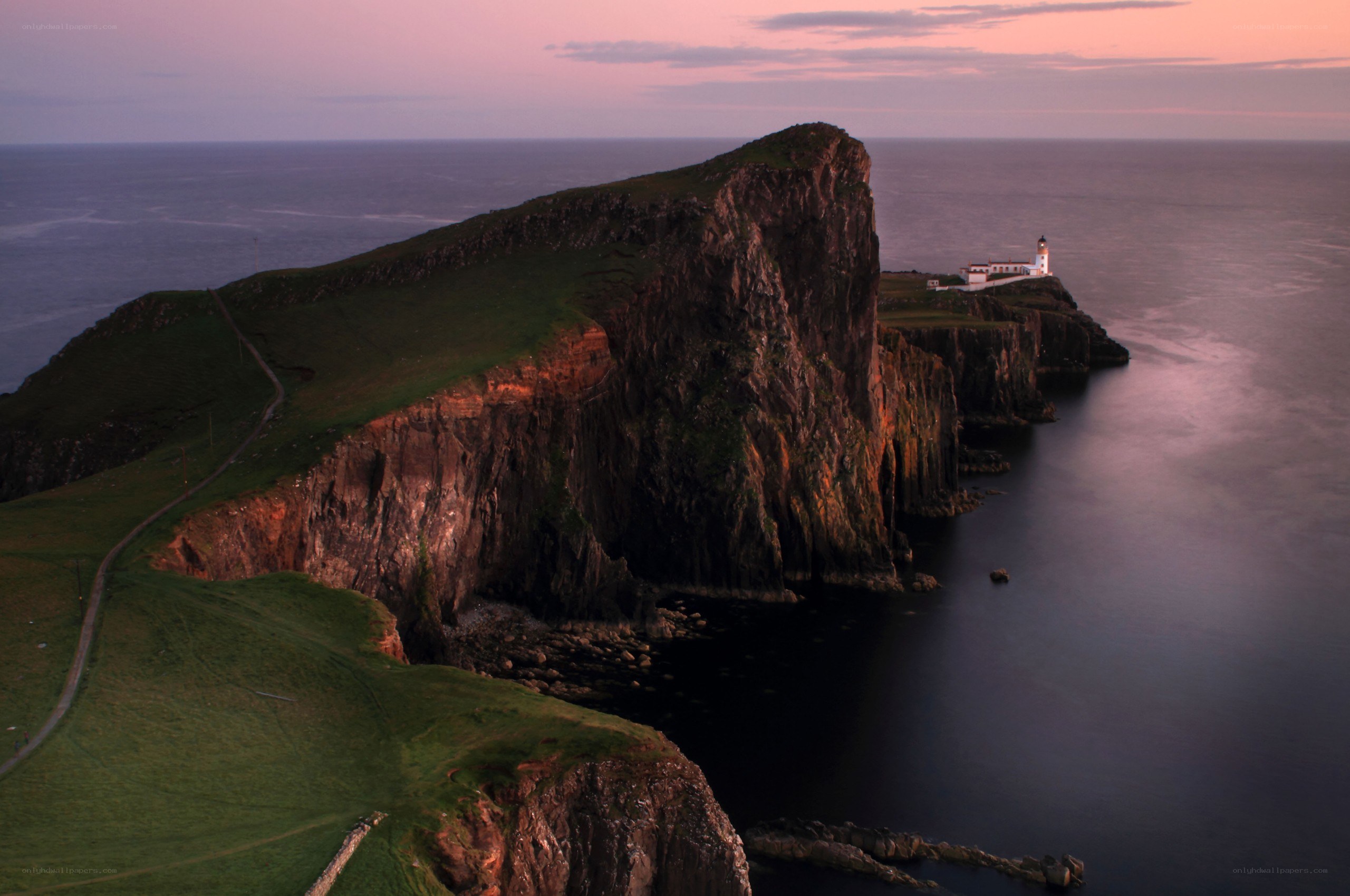 Lighthouse on a cliff at dusk