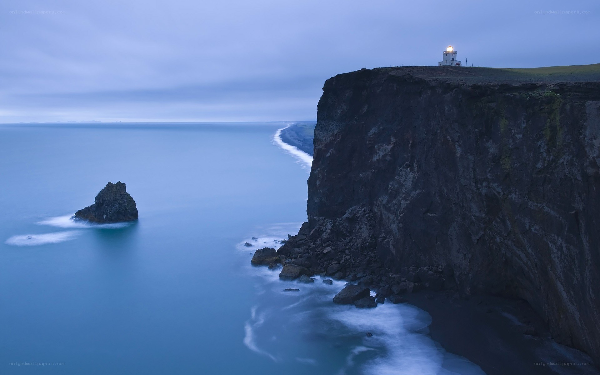 Lighthouse on a cliff at dusk