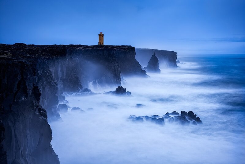 Lighthouse on a cliff at dusk