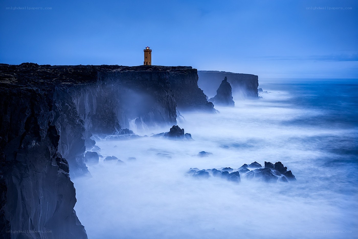 Lighthouse on a cliff at dusk