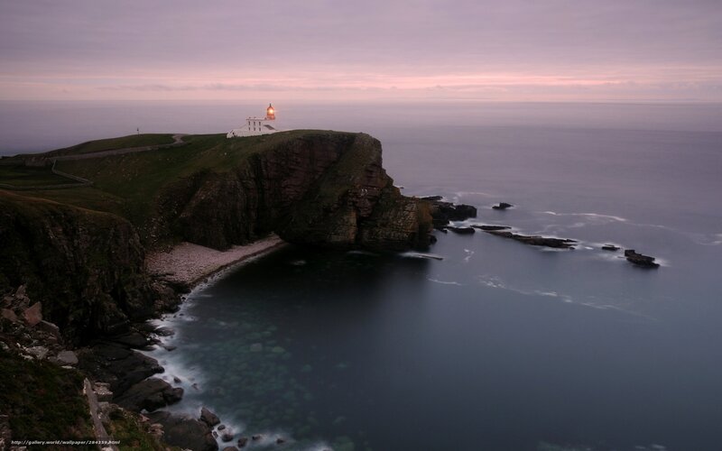 Lighthouse on a cliff at dusk
