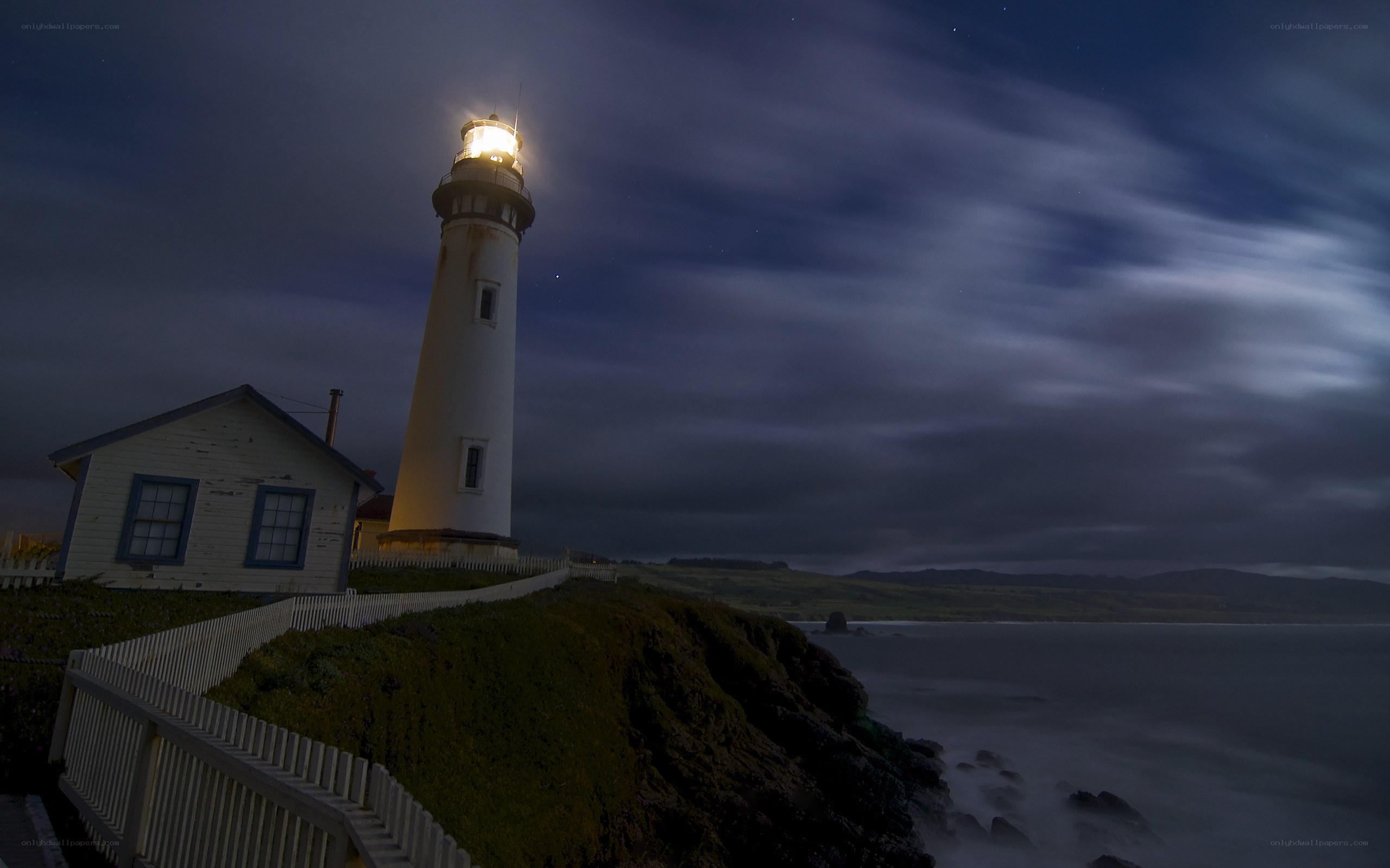 Lighthouse on a cliff at night