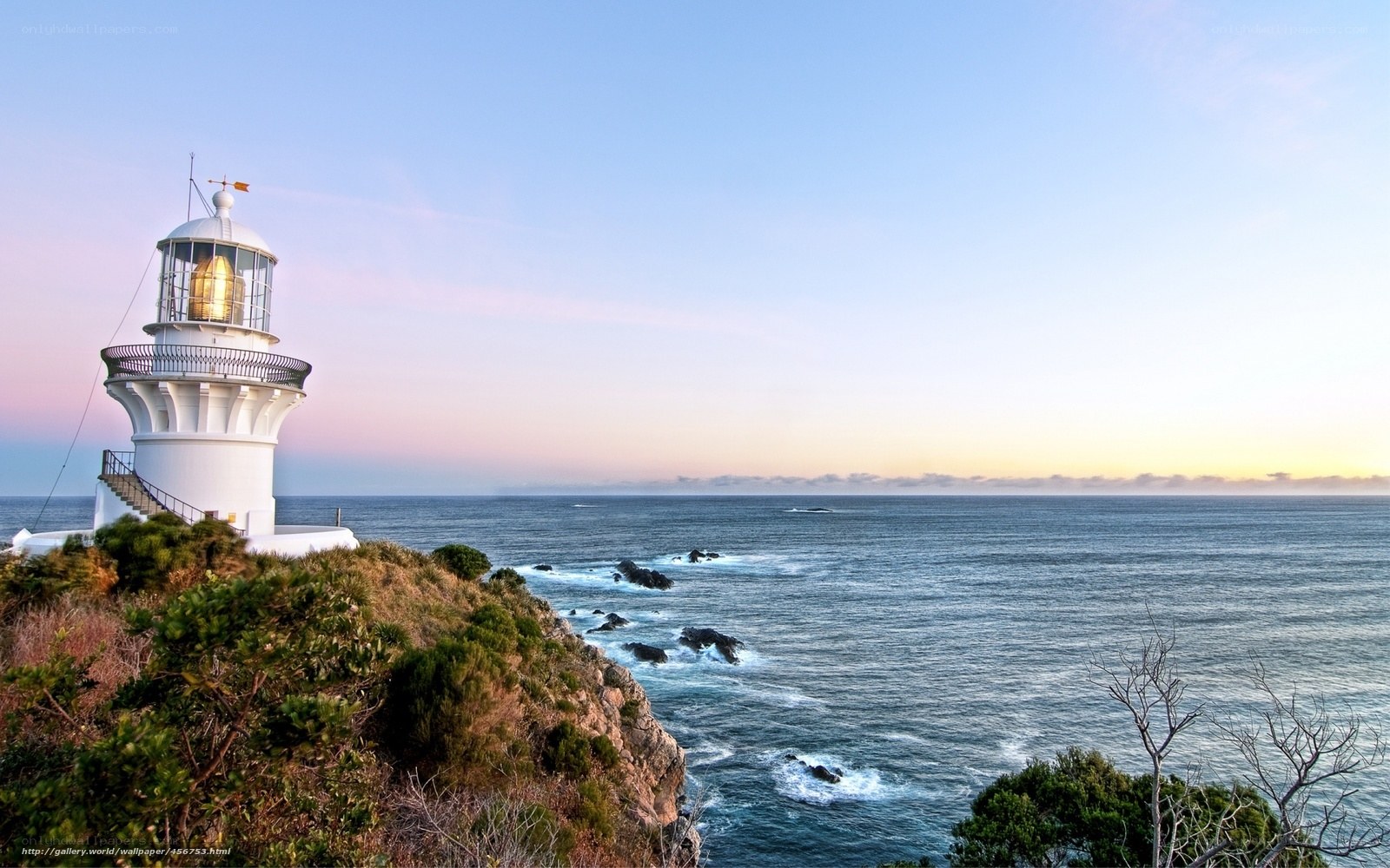 Lighthouse on a cliff at sunset