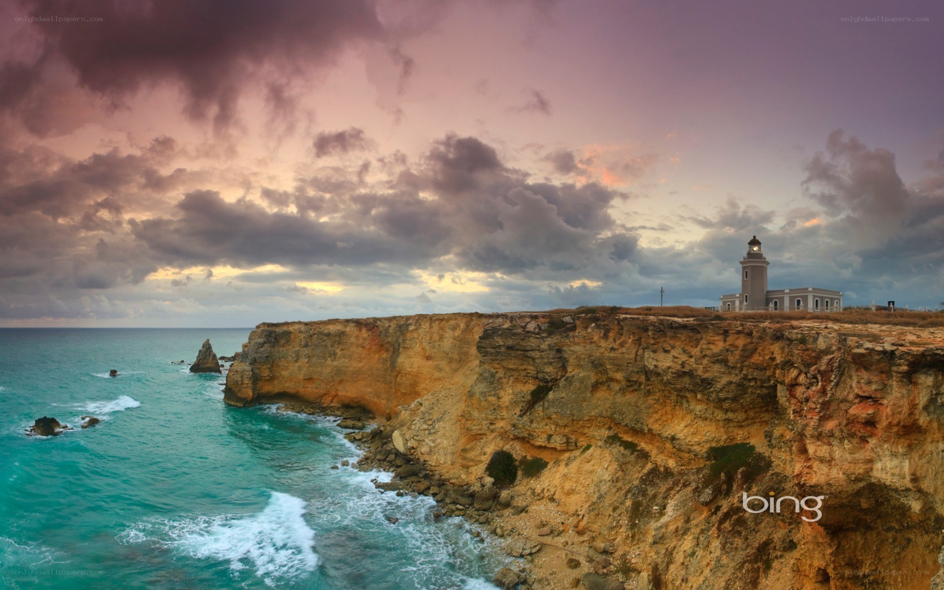 Lighthouse on a cliff at sunset