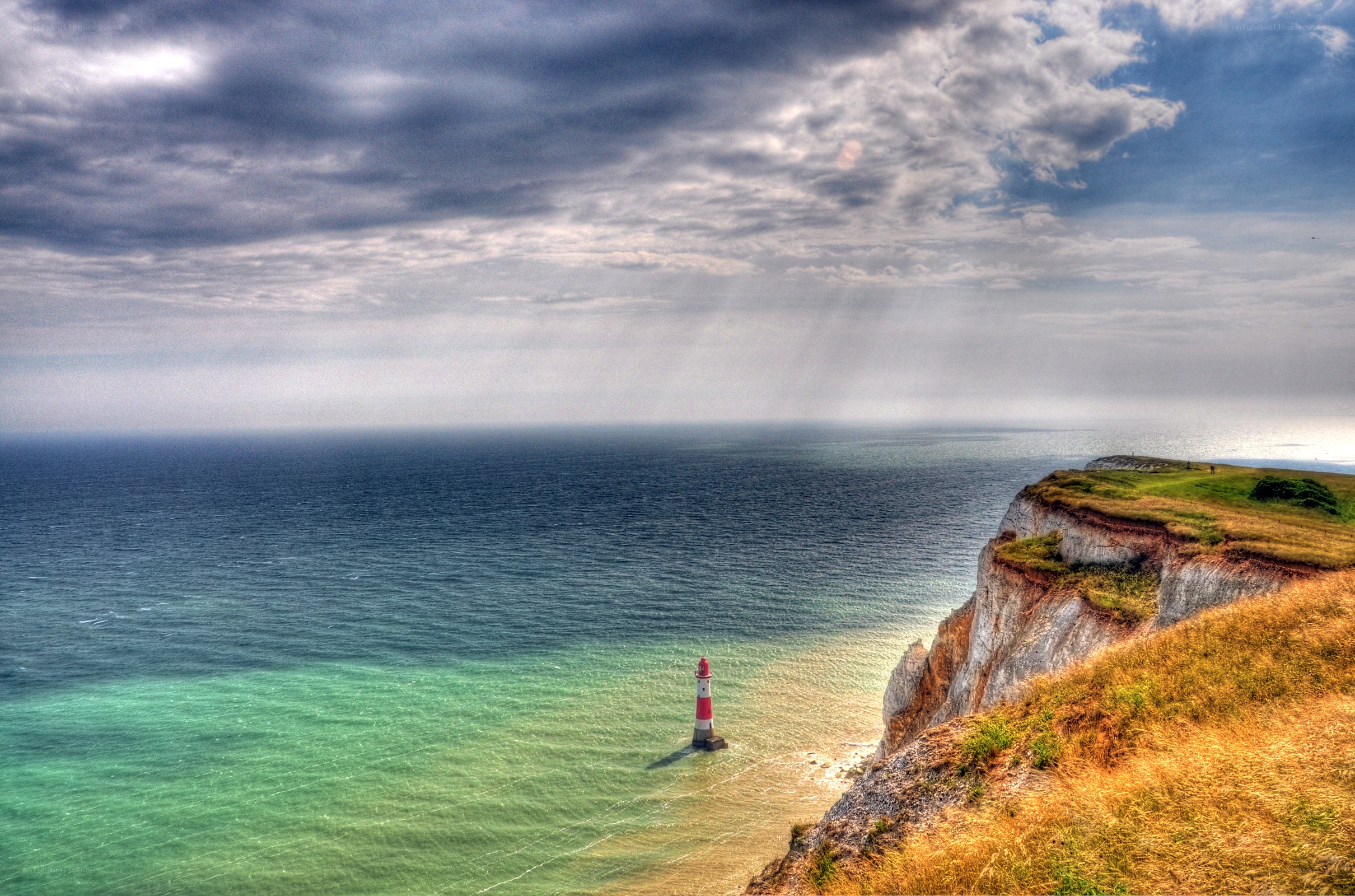 Lighthouse on a cliff by the sea