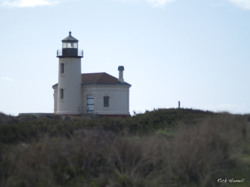 lighthouse on a coastal hill