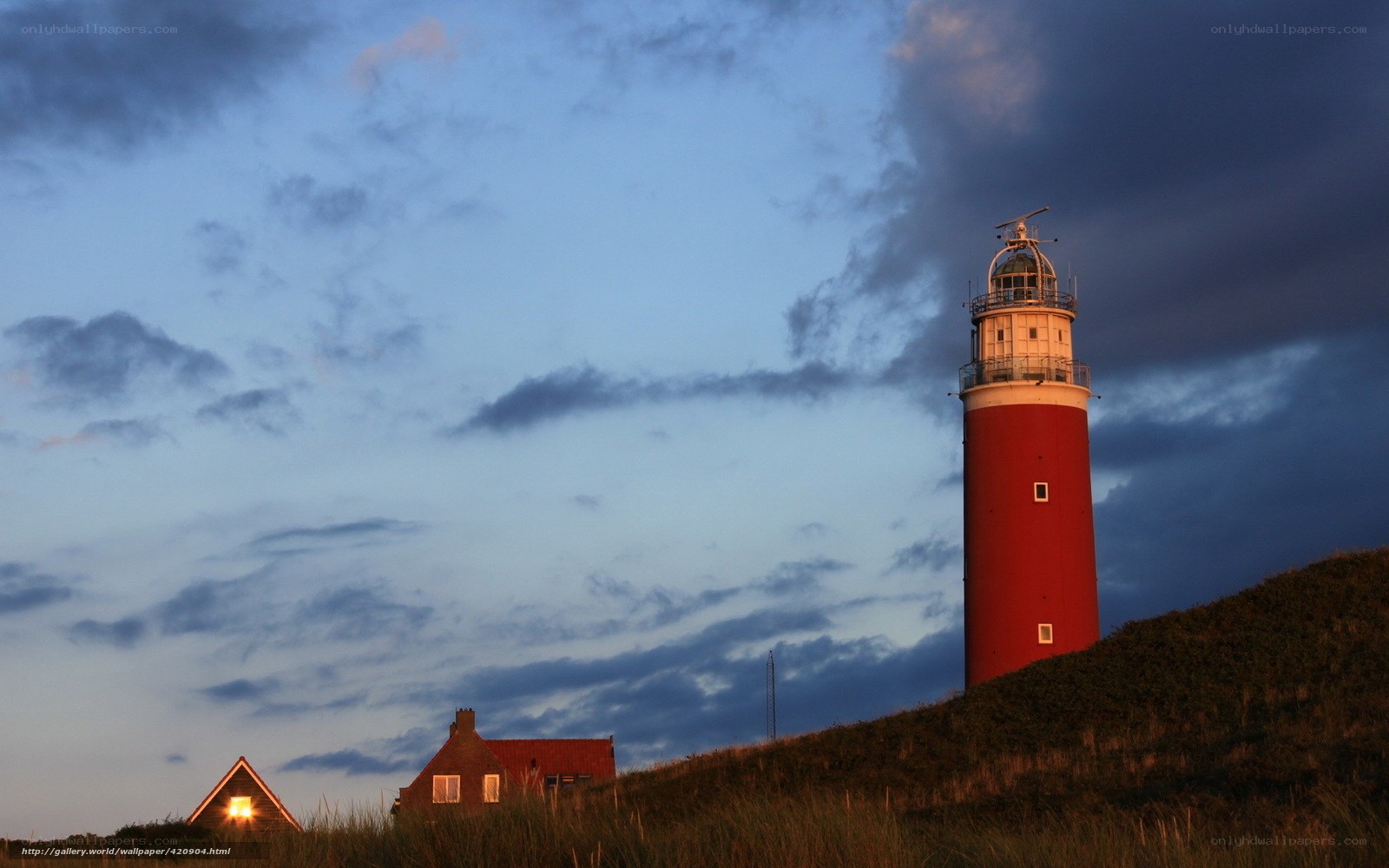 Lighthouse on a dune at dusk