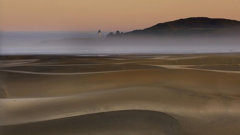 Lighthouse on a foggy beach