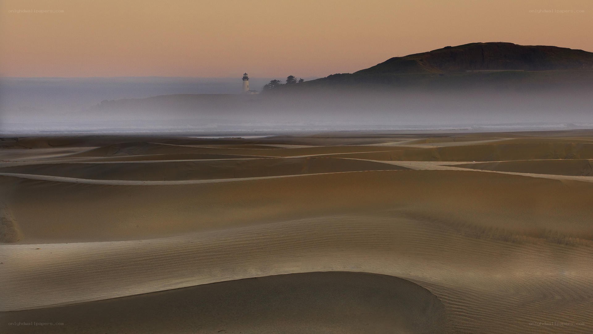 Lighthouse on a foggy beach