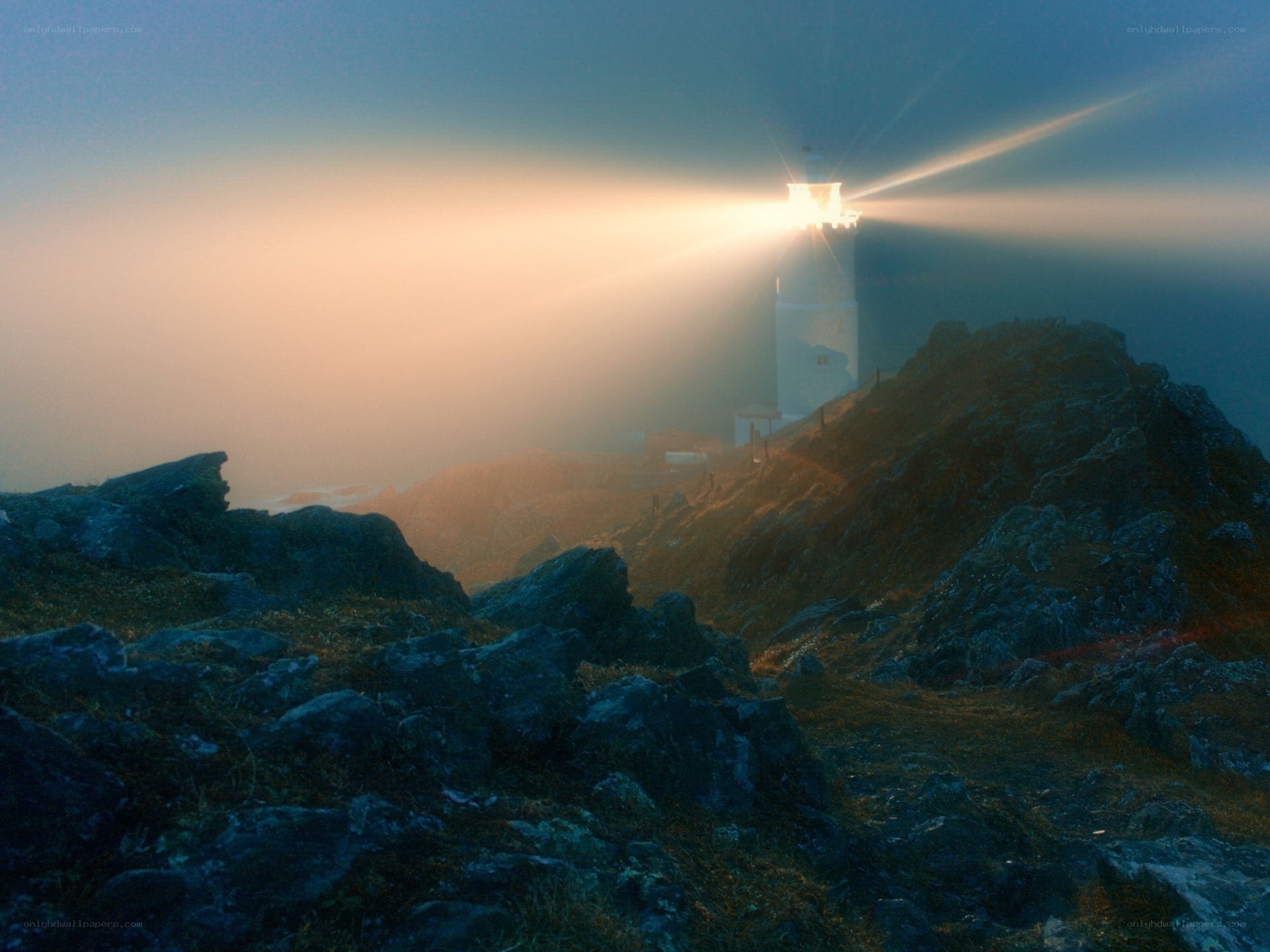 Lighthouse on a foggy cliff