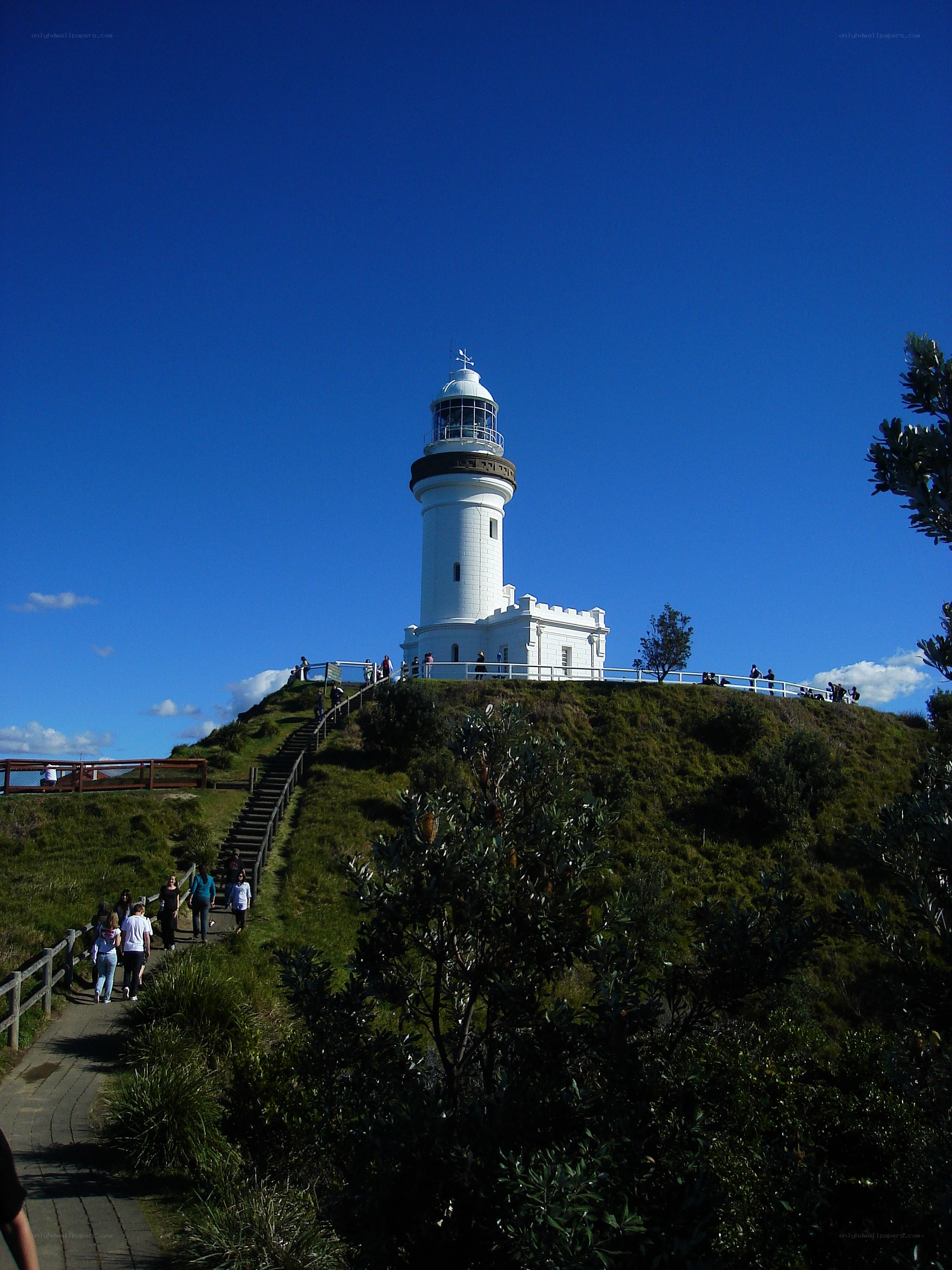lighthouse on a grassy hill