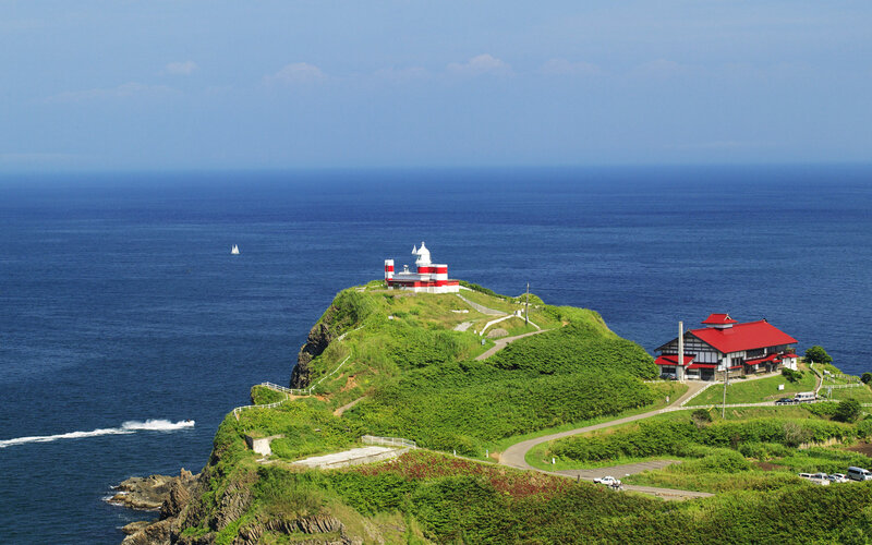 lighthouse on a green cliff